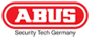 Zu sehen ist das Logo der Marke Abus mit weißem Schriftzug in klaren, fetten Großbuchstaben, eingefasst in einer roten Ellipse.